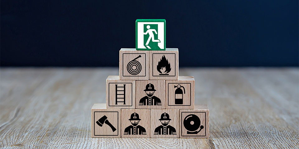 Wooded blocks Stacking with fire escape icon for safety concept.